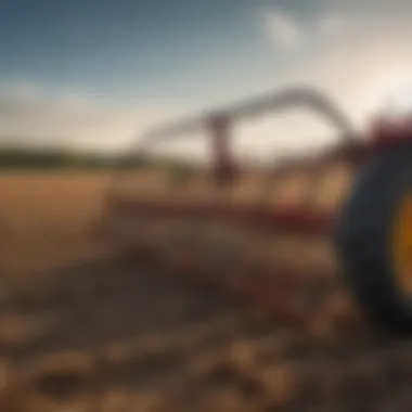 A spring tine fan rake in action within a cultivated field.