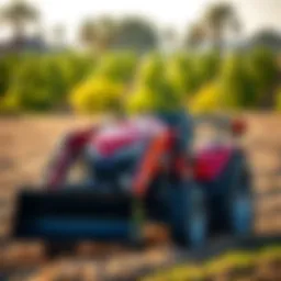 Compact tractor with a front bucket in a field