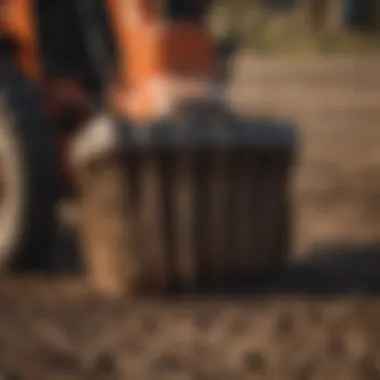 Close-up of power rake teeth engaging the soil